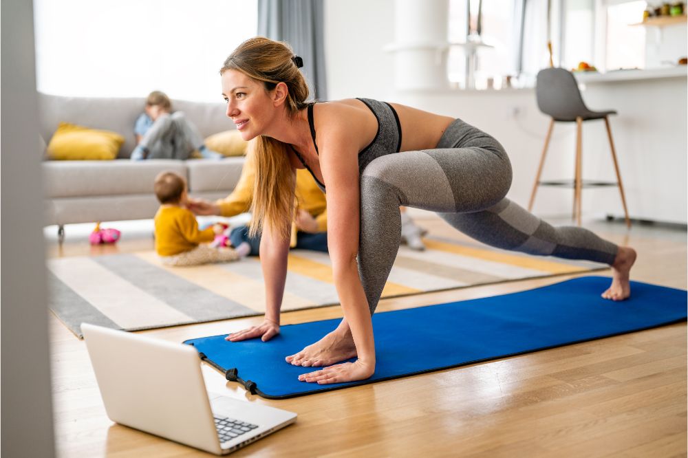 Young woman is exercising yoga at home